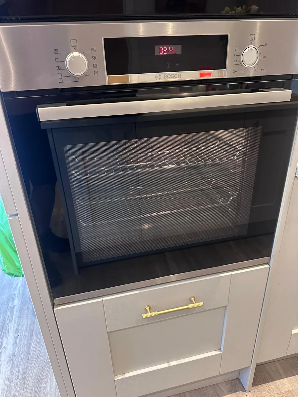 Clean single oven with bright shelves visible through the door after cleaning in Ebrington