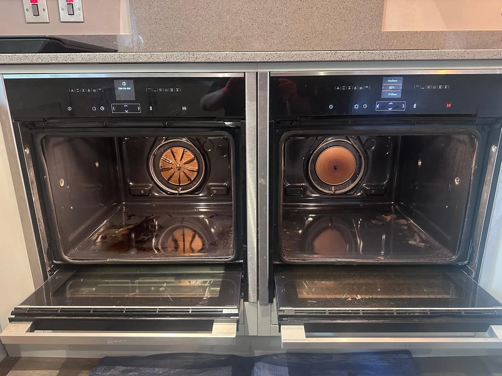 Two open NEFF Slide&Hide oven cavities before cleaning in Hereford